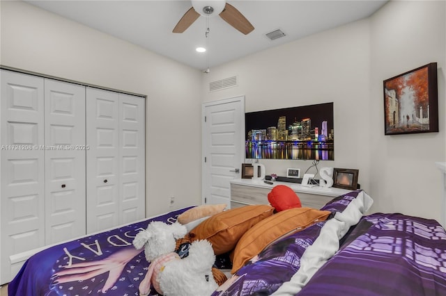 bedroom with ceiling fan, visible vents, and a closet