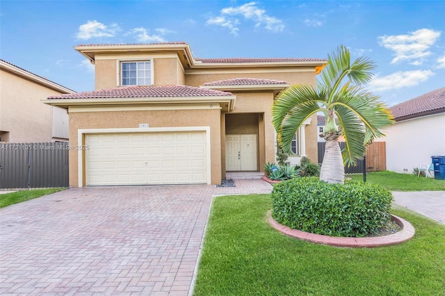 mediterranean / spanish-style home featuring a garage and a front lawn