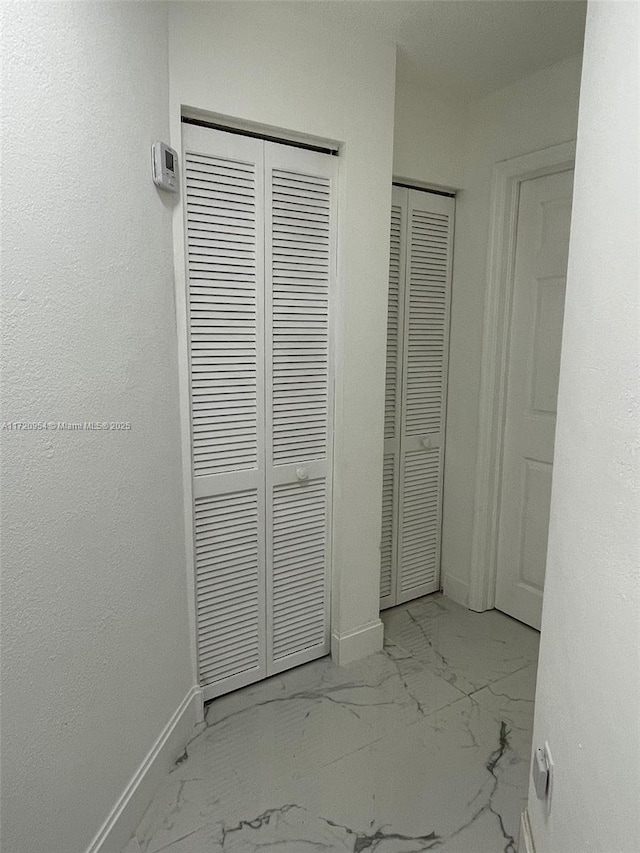 unfurnished bedroom with two closets