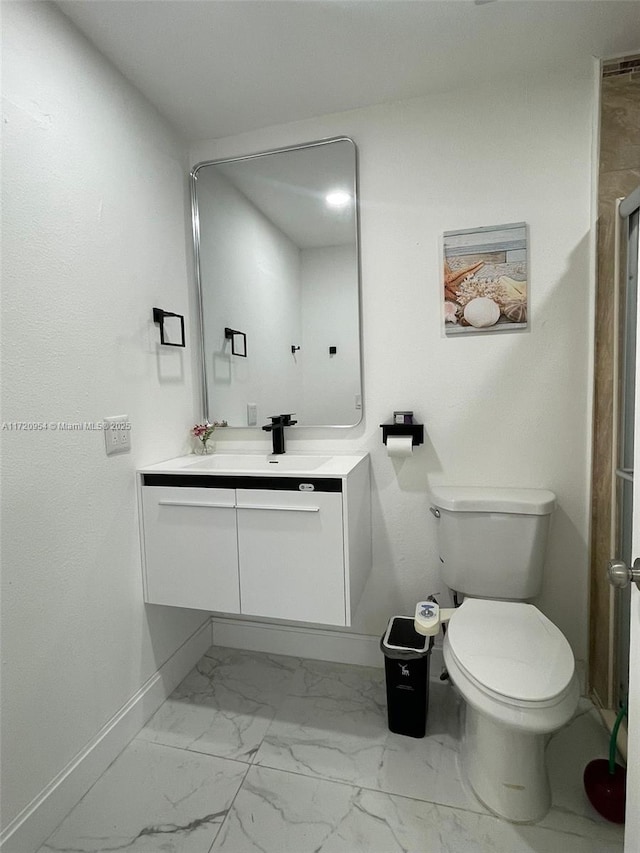 bathroom featuring vanity and toilet