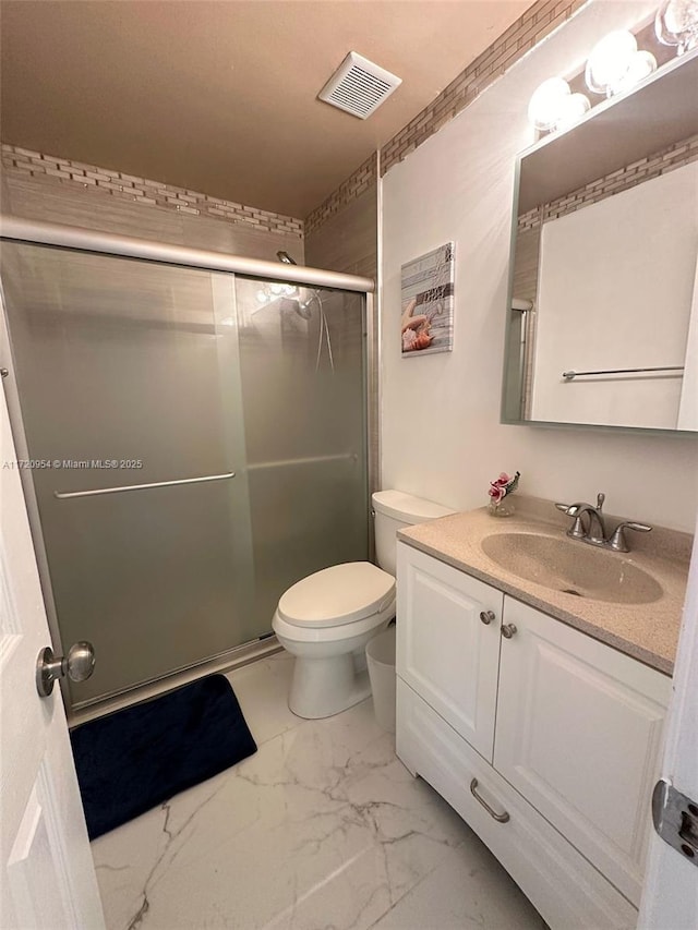 bathroom with vanity, toilet, and an enclosed shower