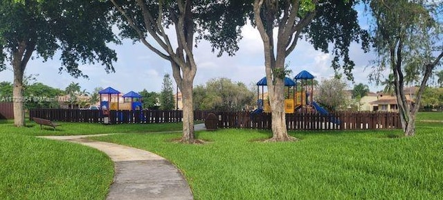 view of home's community with a yard and a playground