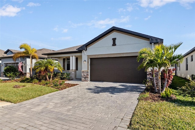 view of front of property with a garage and a front lawn