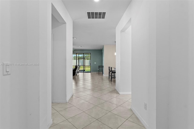 hall with light tile patterned floors