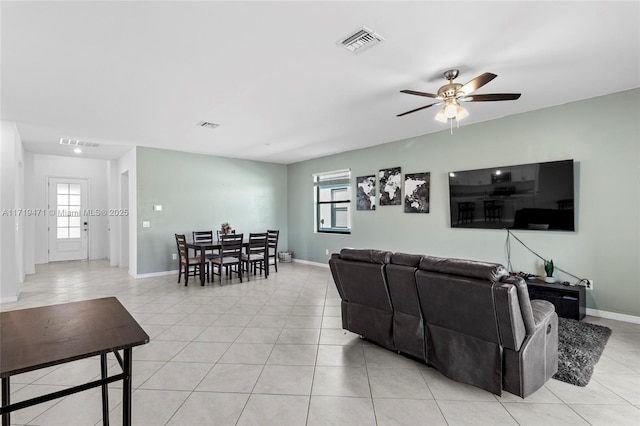 living room with ceiling fan, plenty of natural light, and light tile patterned flooring