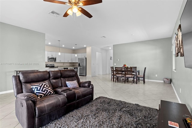 living room featuring ceiling fan and light tile patterned flooring