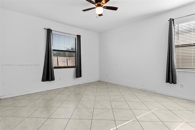 spare room featuring ceiling fan and light tile patterned floors