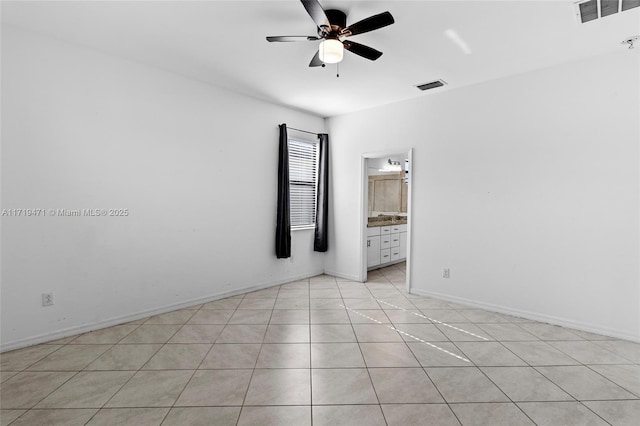 tiled empty room with ceiling fan