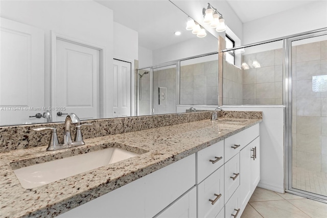 bathroom featuring tile patterned flooring, vanity, and walk in shower