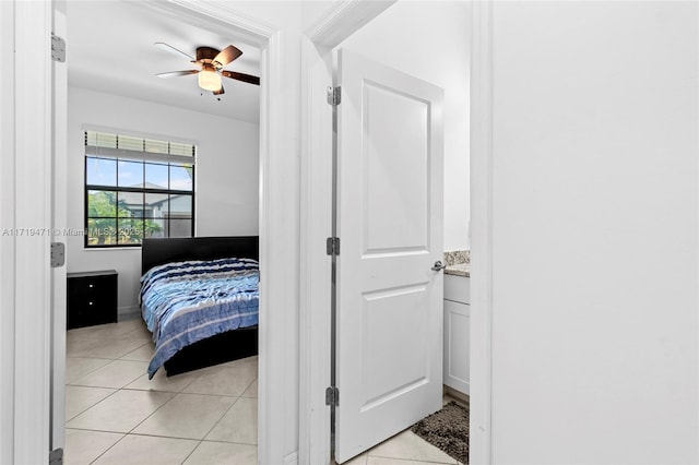 tiled bedroom featuring ceiling fan