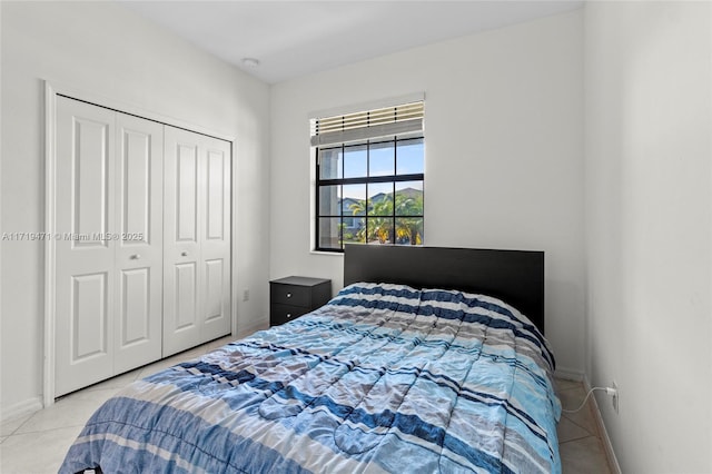 bedroom with a closet and light tile patterned flooring