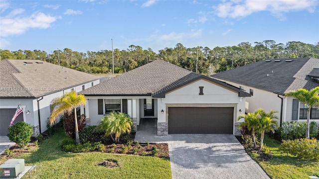 single story home with a garage and a front lawn