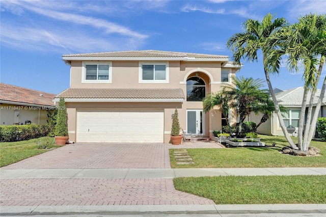 view of front of property with a front yard and a garage