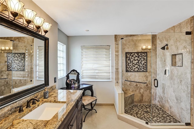 bathroom featuring tile patterned floors, vanity, and a shower with door