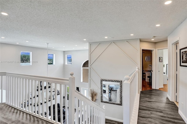 hall featuring dark hardwood / wood-style flooring and a textured ceiling