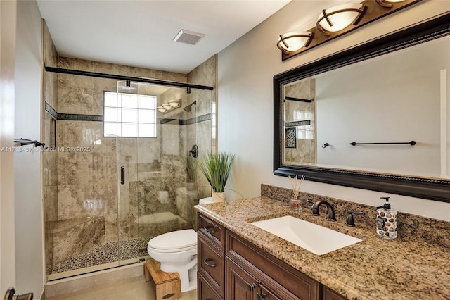 bathroom featuring vanity, toilet, and walk in shower