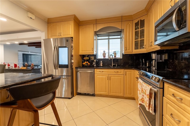 kitchen featuring backsplash, light tile patterned flooring, dark stone countertops, and stainless steel appliances