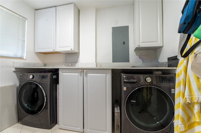 laundry area featuring electric panel, cabinets, light tile patterned floors, and washer / clothes dryer