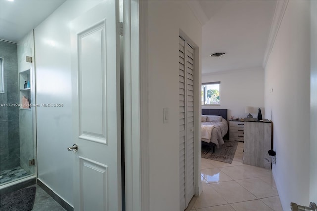 hallway with light tile patterned flooring and crown molding