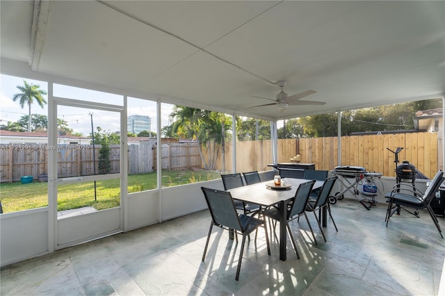 sunroom / solarium featuring ceiling fan