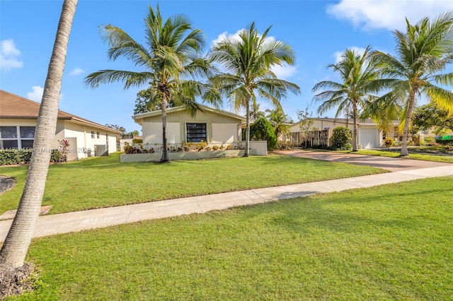 ranch-style house featuring central AC unit and a front yard