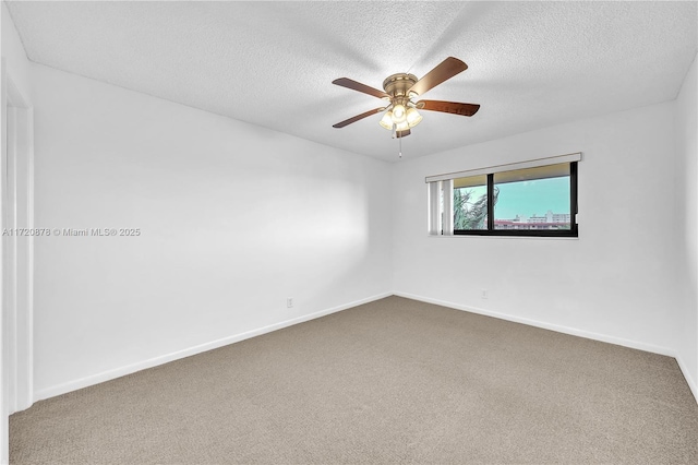 empty room with carpet flooring, ceiling fan, and a textured ceiling