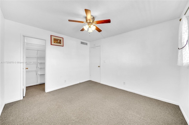 unfurnished bedroom with ceiling fan, carpet floors, and a closet