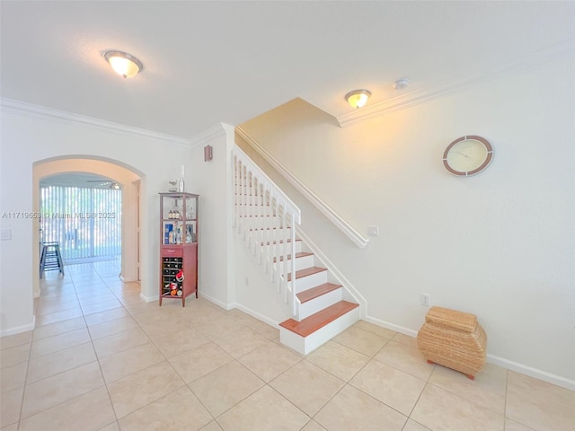 stairway featuring tile patterned floors and ornamental molding