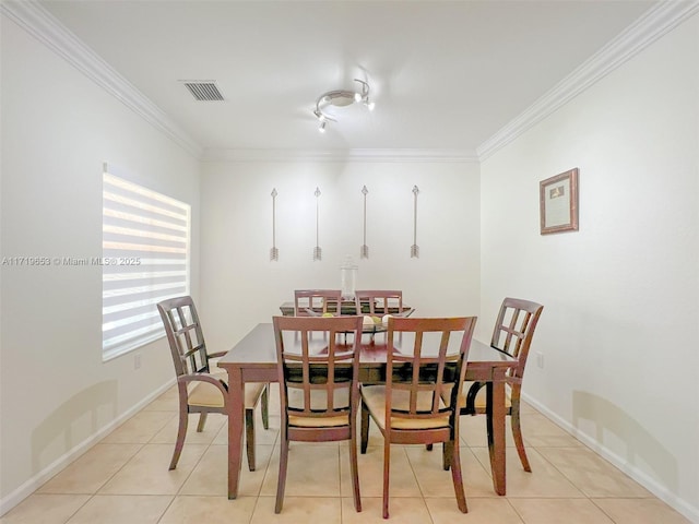 dining area with light tile patterned flooring and ornamental molding