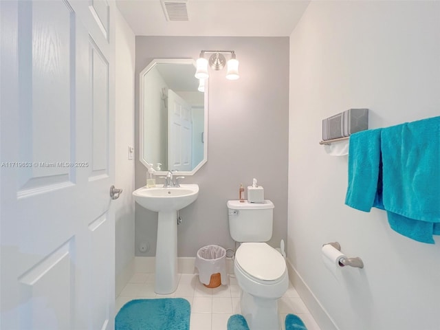 bathroom with tile patterned flooring and toilet