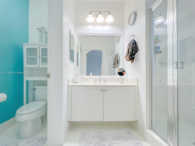 bathroom with tile patterned flooring, vanity, toilet, and a shower with shower door