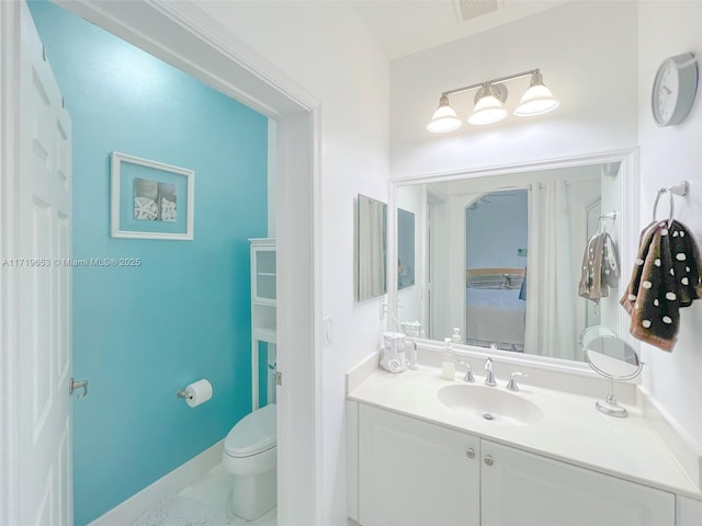 bathroom with vanity and toilet