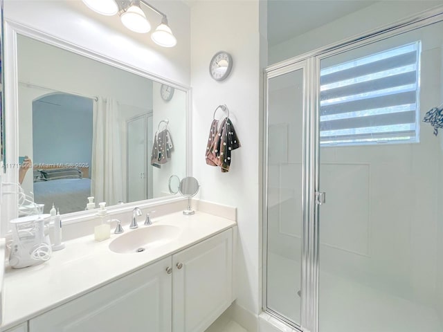 bathroom with vanity and a shower with shower door