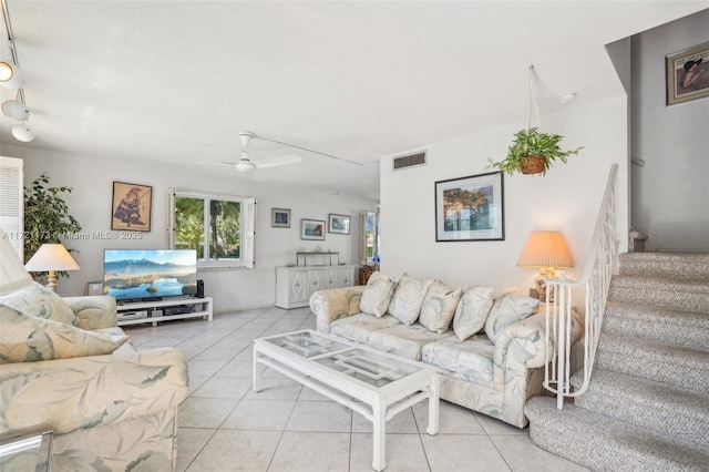 tiled living room featuring ceiling fan