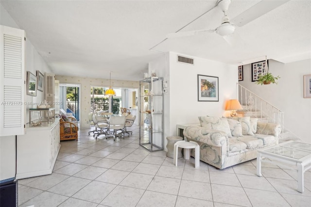 living room featuring light tile patterned floors and ceiling fan