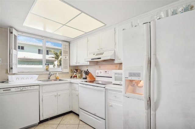 kitchen with white appliances, white cabinets, sink, light tile patterned floors, and custom range hood