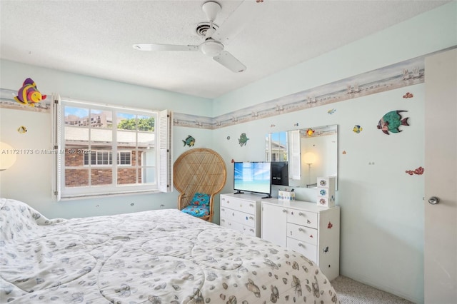 carpeted bedroom with ceiling fan and a textured ceiling