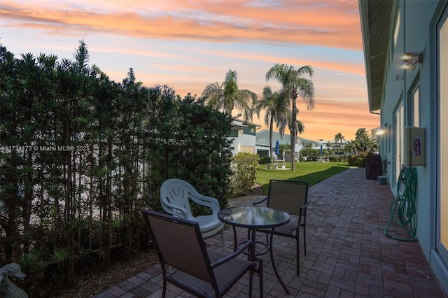 patio terrace at dusk with a yard