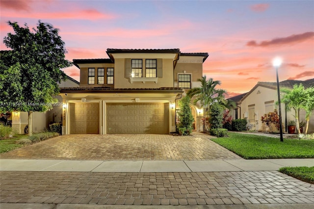 mediterranean / spanish house with a garage