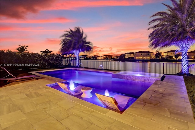 pool at dusk featuring a patio