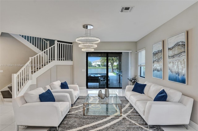 tiled living room with an inviting chandelier