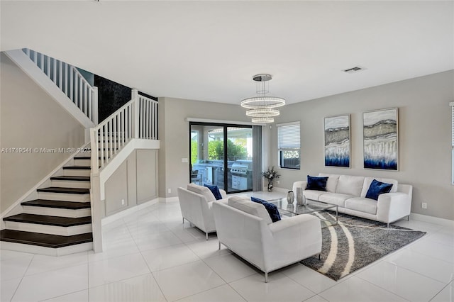 living room featuring a chandelier and light tile patterned floors