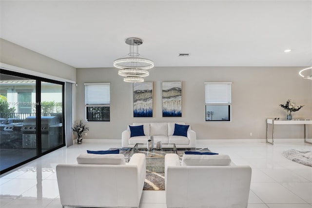 living room with light tile patterned floors and a chandelier