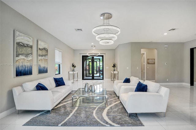 living room with light tile patterned floors, french doors, and a chandelier