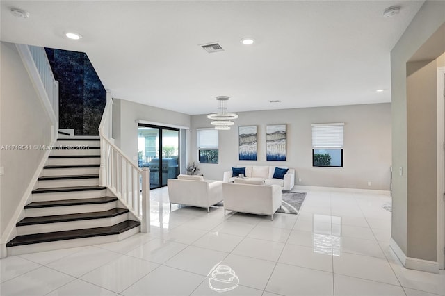 living room with light tile patterned flooring and a chandelier