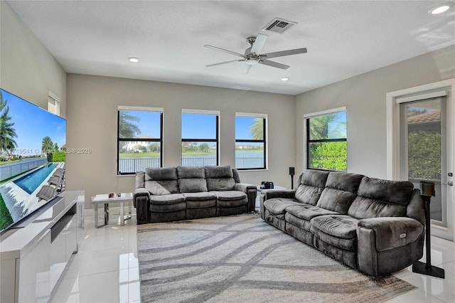 tiled living room with ceiling fan