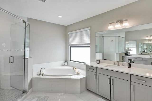 bathroom with tile patterned flooring, vanity, and shower with separate bathtub