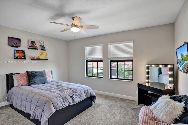 bedroom featuring ceiling fan and carpet