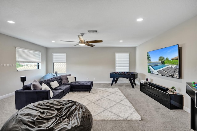 living room featuring ceiling fan and light colored carpet