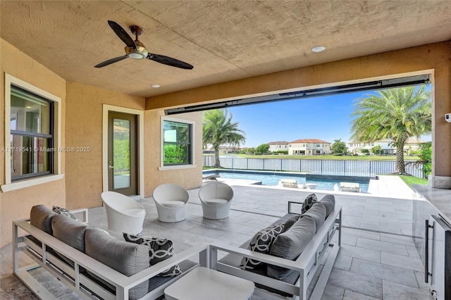 view of patio with outdoor lounge area, a fenced in pool, and ceiling fan